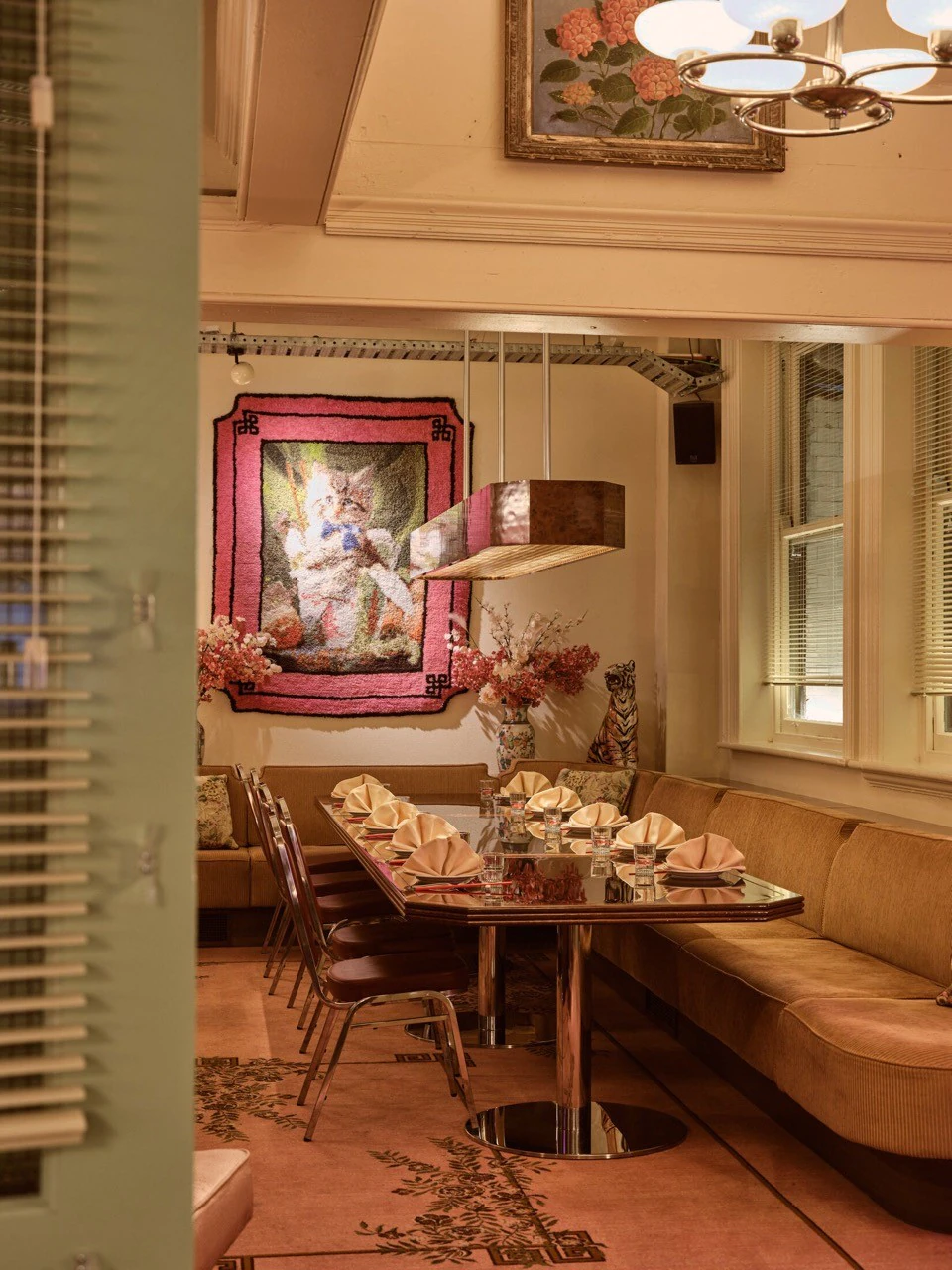 A continuous upholstered banquette beside the dining tables at Good Luck Eating House